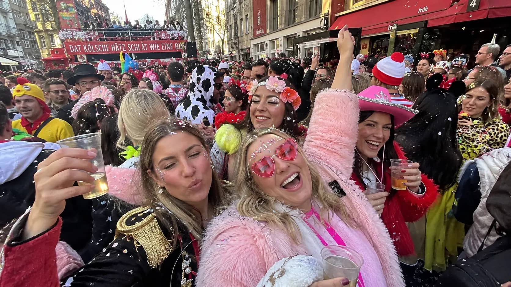 People in costumes celebrating the start of the carnival season in Cologne city centre